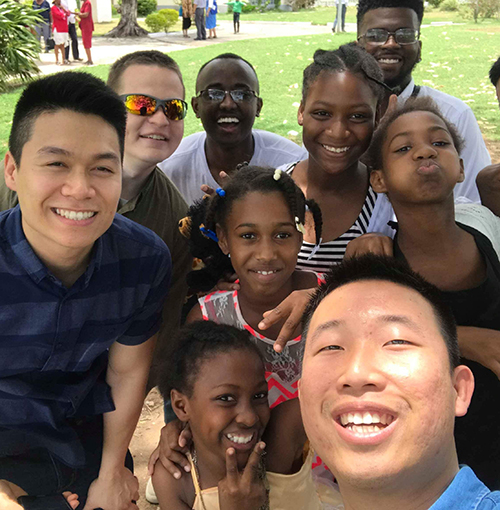 Mission Jamaica participants take a selfie with Jamaican children