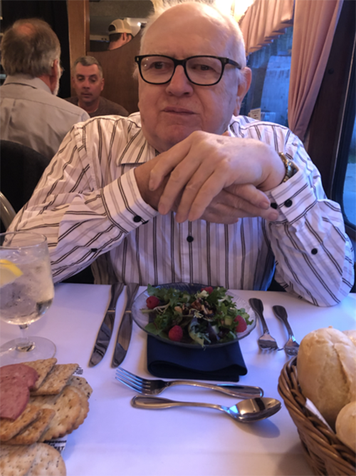 Bro. Bernie Scherger, SVD sits at a dinner table