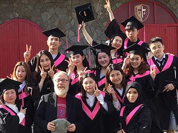 Fr. Dan Bauer poses with graduating students