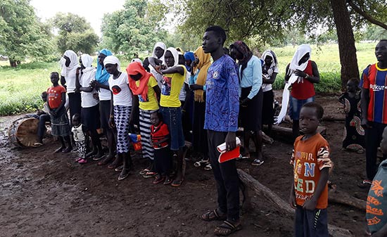 Group of Africans standing together under a tree