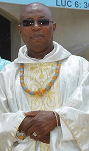 Fr. Pierre poses in priestly vestments