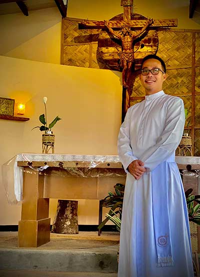 Bro. Mark Paglicawan standing near the altar in a church
