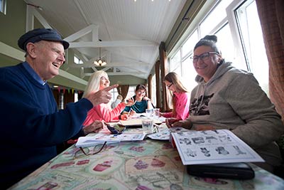 Ukrainian refugees share a smile at a dining room table