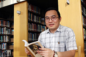 Truong An Nguyen reading in a library