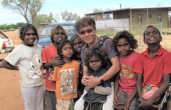 Fr. Michael Quang Nguyen posing with a group of Aboriginal children