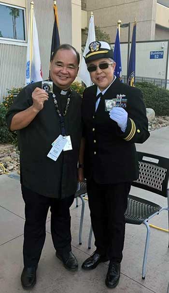 Fr. Ignacio standing with a woman who is wearing a military uniform