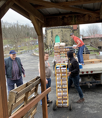 Divine Word students unload supplies at St. Thomas Catholic Church - Gassaway, West Virgina