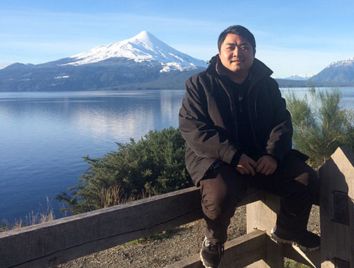 Frt. Thinh Ngo, SVD, poses by mountain range