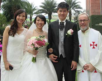 Fr. Dan Bauer poses with newly married couple