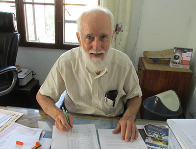 Fr Fred Timp working at a desk