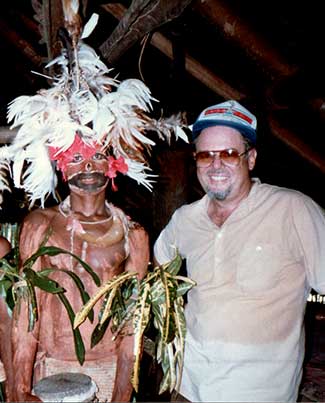 Man in ceremonial dress standing next to American missionary